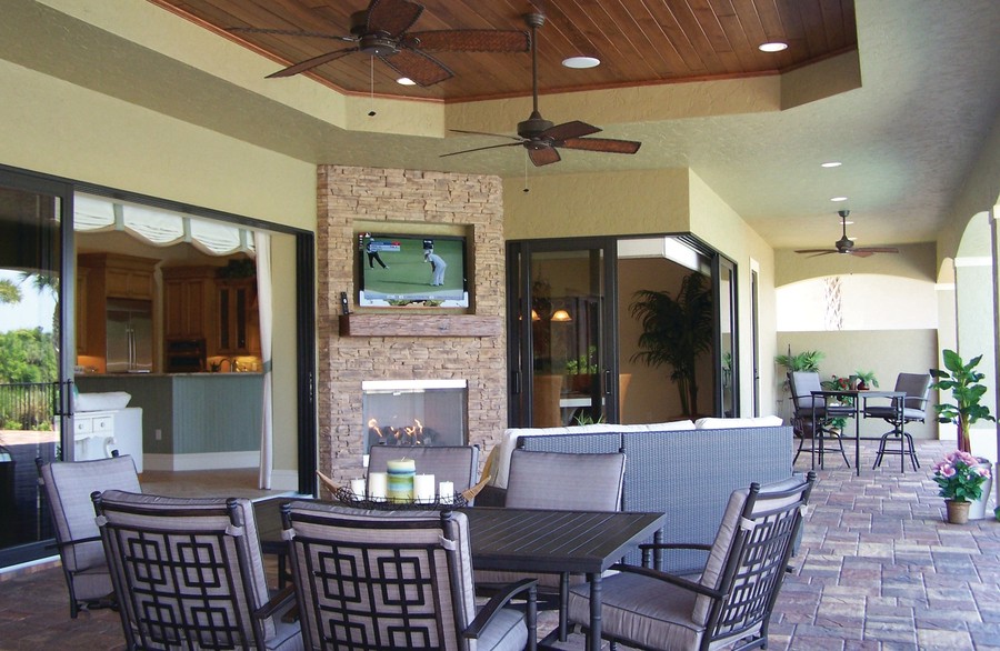 Terrace with dining table, fireplace and outdoor smart TV.