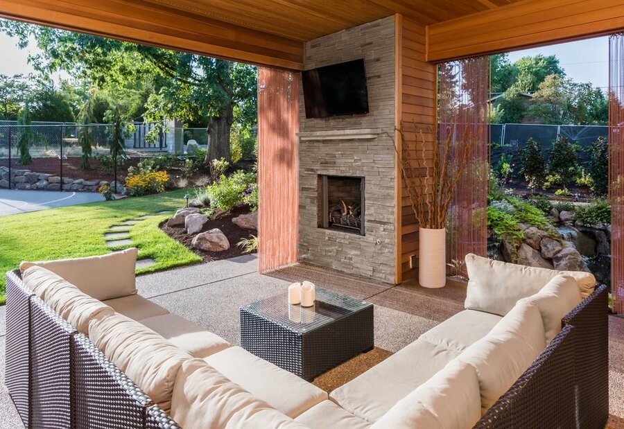 Backyard covered patio with an Outdoor TV and seating area.